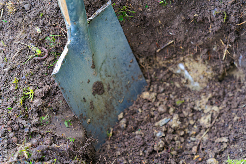 Close-up of spade at garden with soil and earthworm at Swiss City of Zürich on a rainy autumn day. Photo taken October 8th, 2024, Zurich, Switzerland.