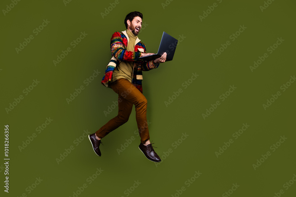 Photo of elegant handsome gentleman office worker wear stylish clothes hold netbook isolated on khaki color background Photo of elegant handsome gentleman office worker wear stylish clothes hold netbook isolated on khaki color background