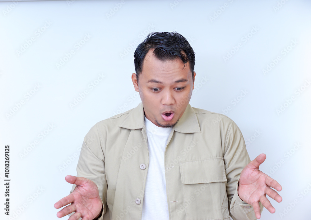 A surprised man reacts with astonishment, expressing his disbelief. A surprised man reacts with astonishment, expressing his disbelief.