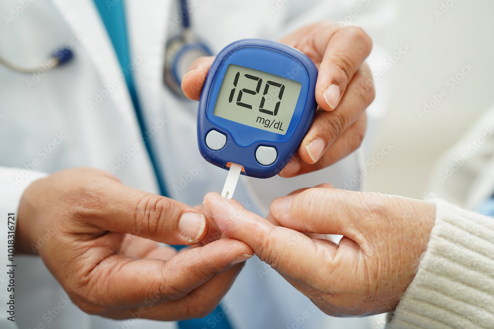 Asian doctor using digital glucose meter for check sample blood sugar level to treatment diabetes. Asian doctor using digital glucose meter for check sample blood sugar level to treatment diabetes.