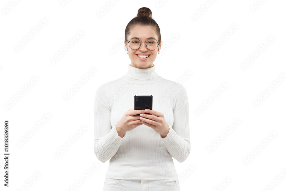 Young woman holding phone in hands, smiling happily at camera Young woman holding phone in hands, smiling happily at camera