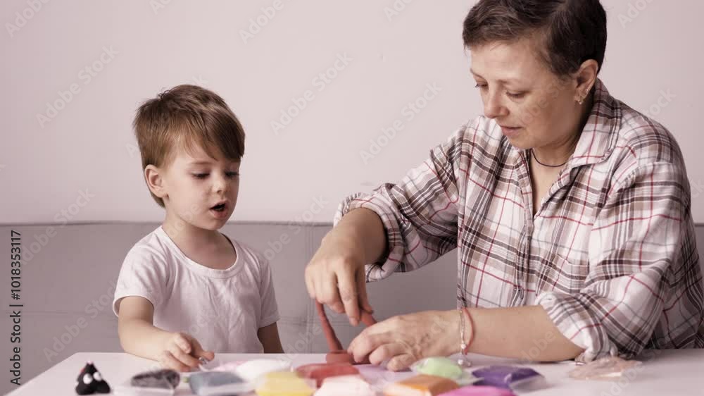Young mother and her child moulding together from plasticine figures Young mother and her child moulding together from plasticine figures