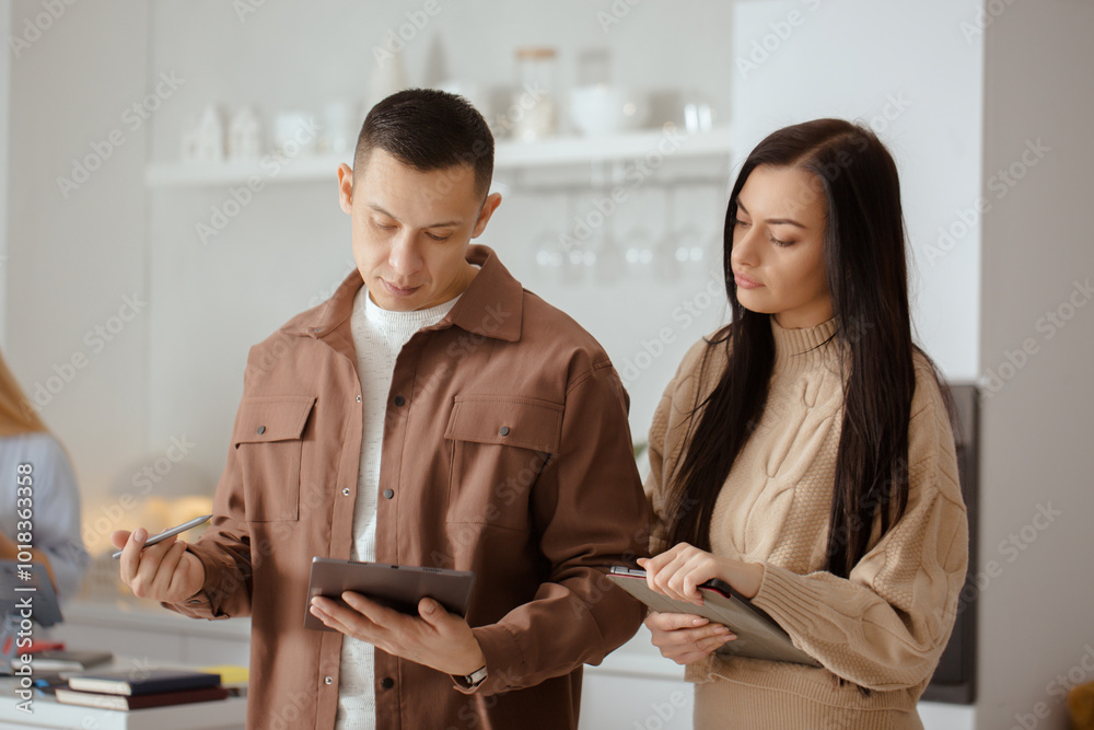Man and a woman are looking at a tablet