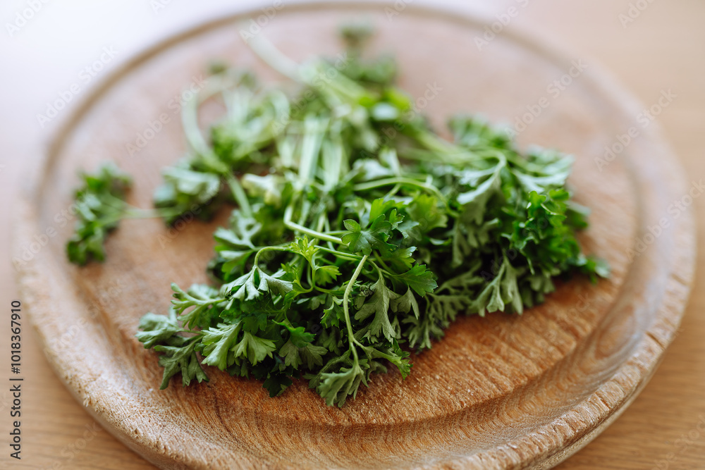 dried parsley on wooden round board dried parsley on wooden round board