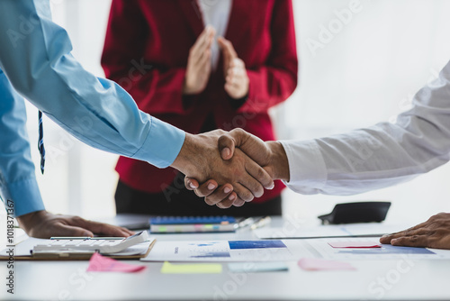 Business people shake hands at a meeting to congratulate colleagues and cooperate in work.