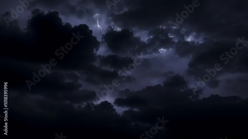 Lightning illuminating dark storm clouds creates a dramatic scene in the night sky. Ominous weather conditions signal the power and energy of nature during a thunderstorm