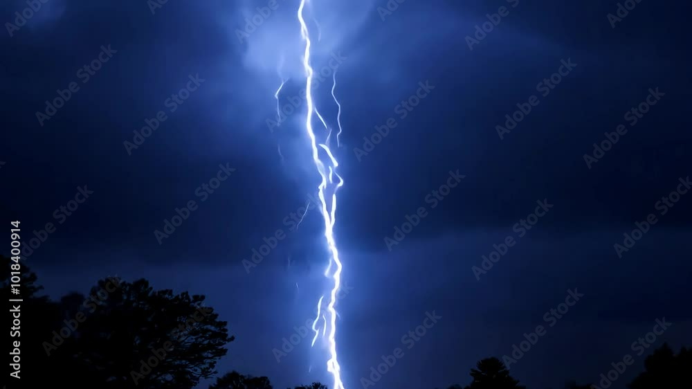 Bright lightning bolts streaking across dark clouds create a dramatic ambiance during a stormy night. Powerful flashes of electricity reveal the raw intensity of nature's forces