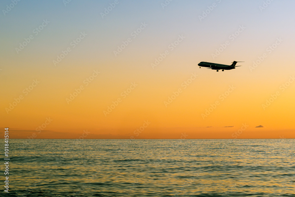 plane landing over sea at sunset. Black sea, Batumi, Georgia plane landing over sea at sunset. Black sea, Batumi, Georgia
