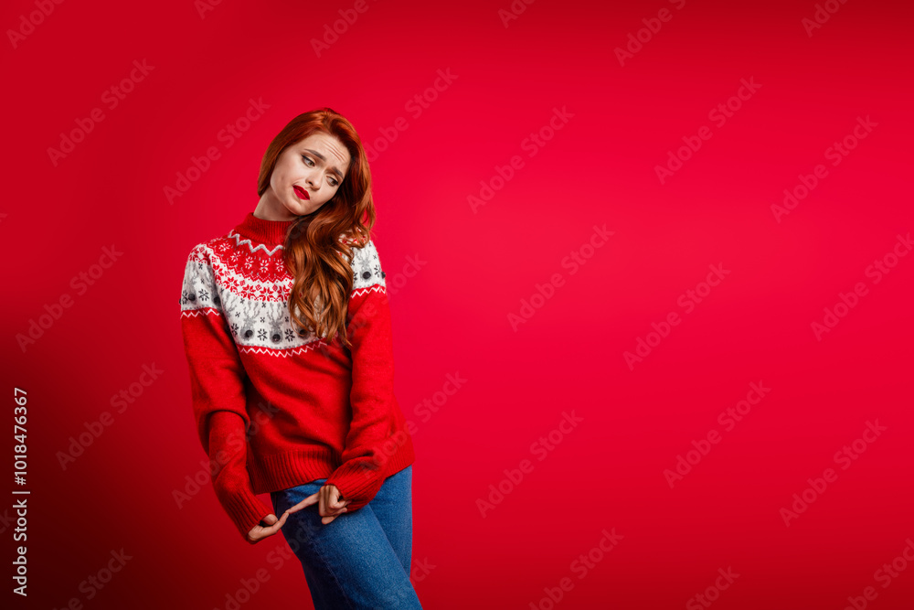 Full length body photo of funny cute modest girl wearing xmas sweater posing candid near billboard christmas sale isolated on red color background Full length body photo of funny cute modest girl wearing xmas sweater posing candid near billboard christmas sale isolated on red color background