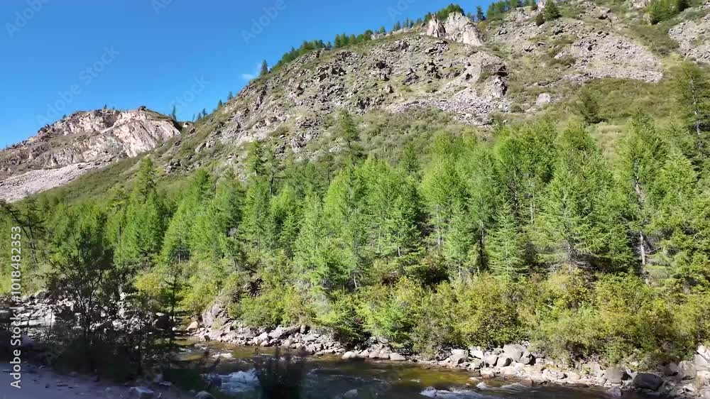 An extreme car tour through mountainous terrain, along a stormy river. An extreme car tour through mountainous terrain, along a stormy river.