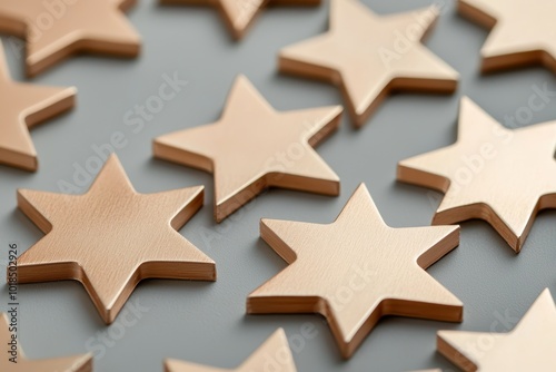 Minimalist stars in soft gold, evenly spaced on a light grey background for a clean, modern holiday look