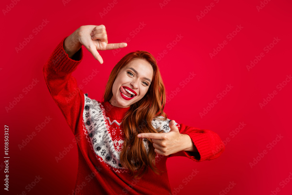 Photo of young creative content maker girl doing event entertainment demonstrate frame gesture with her fingers isolated on red color background Photo of young creative content maker girl doing event entertainment demonstrate frame gesture with her fingers isolated on red color background