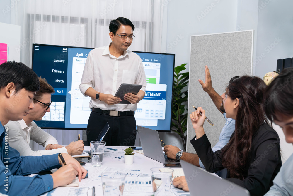 Project manager communicate and collaborate with team using project management software display on monitor, tracking progress of project task and making schedule plan at meeting table. Prudent Project manager communicate and collaborate with team using project management software display on monitor, tracking progress of project task and making schedule plan at meeting table. Prudent