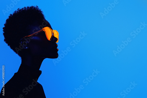 Modern silhouette with orange eyewear in deep blue