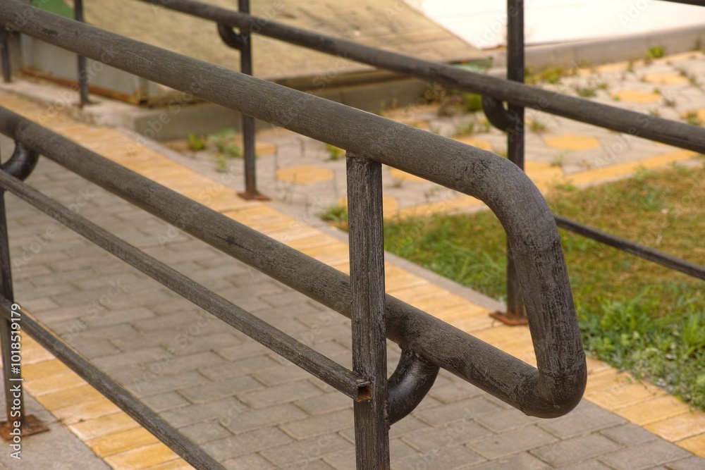 Close-up shot of handrail of wheelchair ramp at an apartment building Close-up shot of handrail of wheelchair ramp at an apartment building