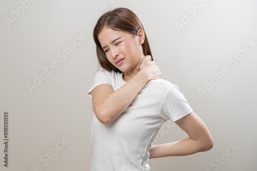 Pain body muscles stiff problem, asian young woman, girl painful with neck pain body ache from work, holding massaging rubbing shoulder hurt, sore on white background. Health care and medicine concept