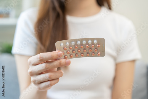 Cuadro en lienzo Contraception and pregnancy, menstruation concept, birth control pills asian young woman hand holding hormonal oral contraceptive medicine, take pharmaceutical to prevention, safe virus sex disease