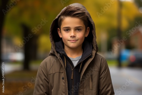 portrait of a boy in a jacket on a background autumn park