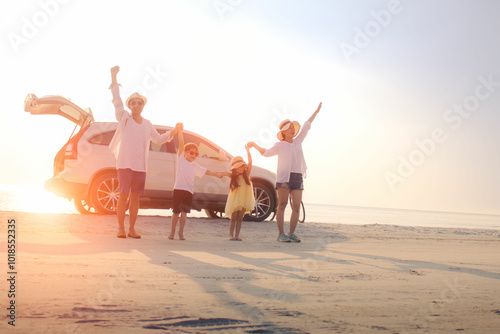 The family travel by car and they are walking relax on the beach. Father mother daughter and son are activity joyful the outdoor.