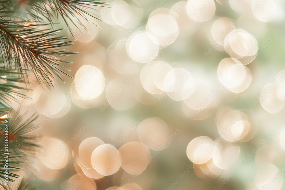 A close up of pine tree branches with soft, blurred bokeh lights in background creates warm, festive atmosphere. This image evokes feelings of holiday cheer and tranquility