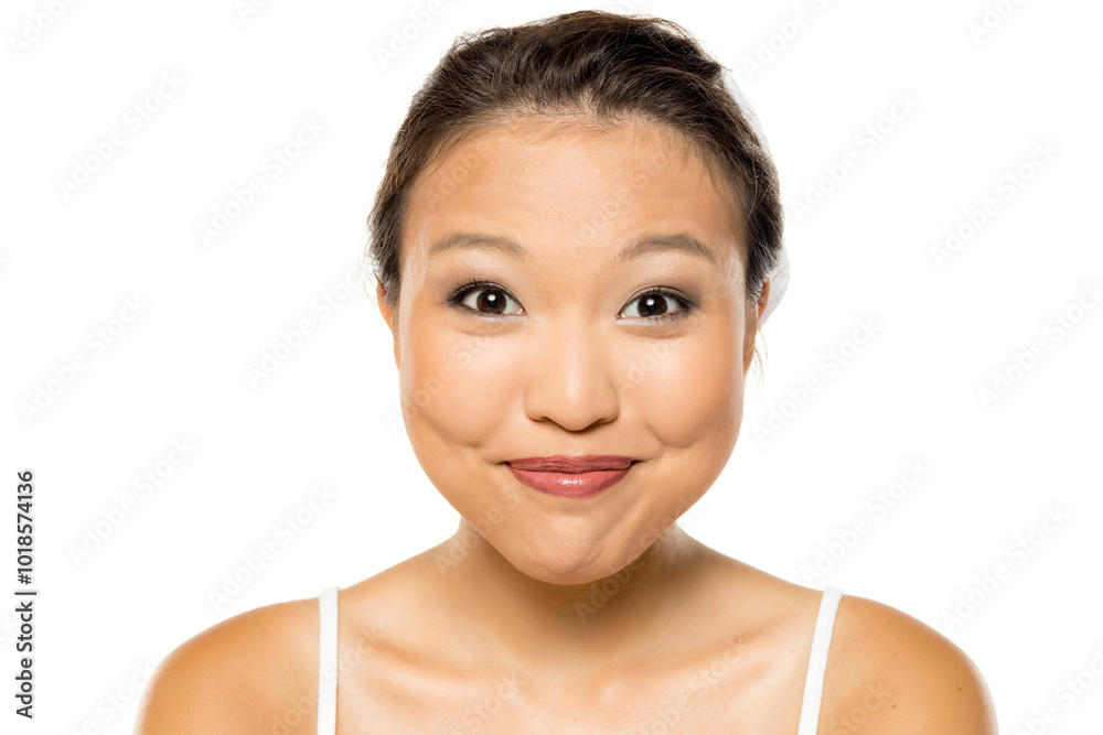 Portrait of a beautiful young smiling Asian woman posing with makeup on white studio background. Portrait of a beautiful young smiling Asian woman posing with makeup on white studio background.