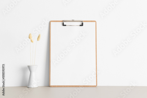 Wooden clipboard mockup with a lagurus on the beige table.