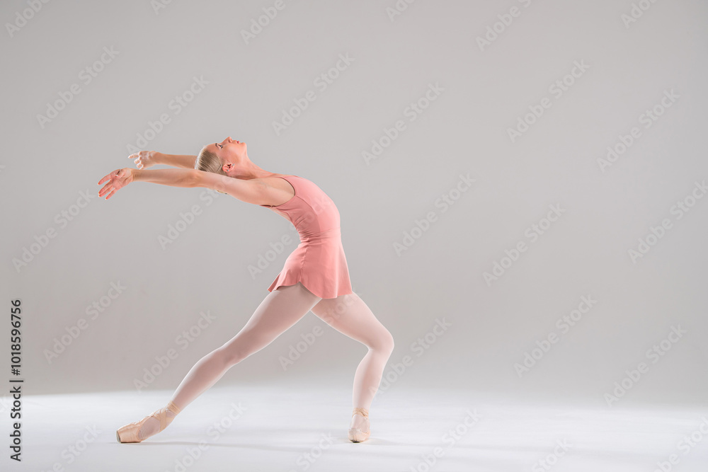 Ballerina in pink leotard dancing on white background. Ballerina in pink leotard dancing on white background.