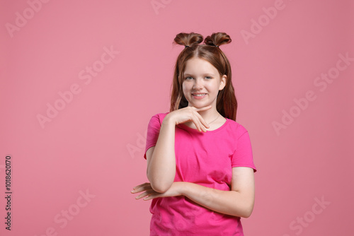 Portrait of teenage girl on pink background, space for text