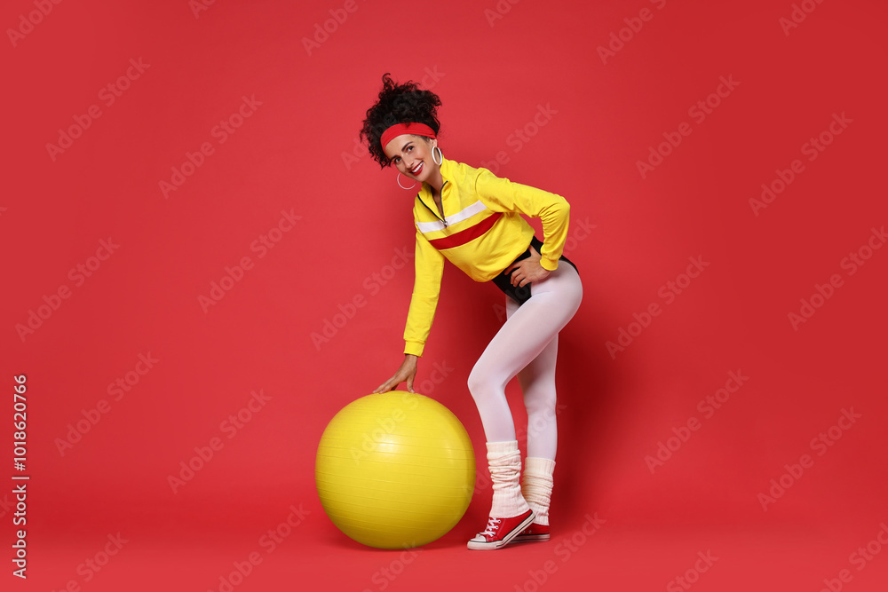 Aerobics. Happy woman with fitness ball on red background Aerobics. Happy woman with fitness ball on red background