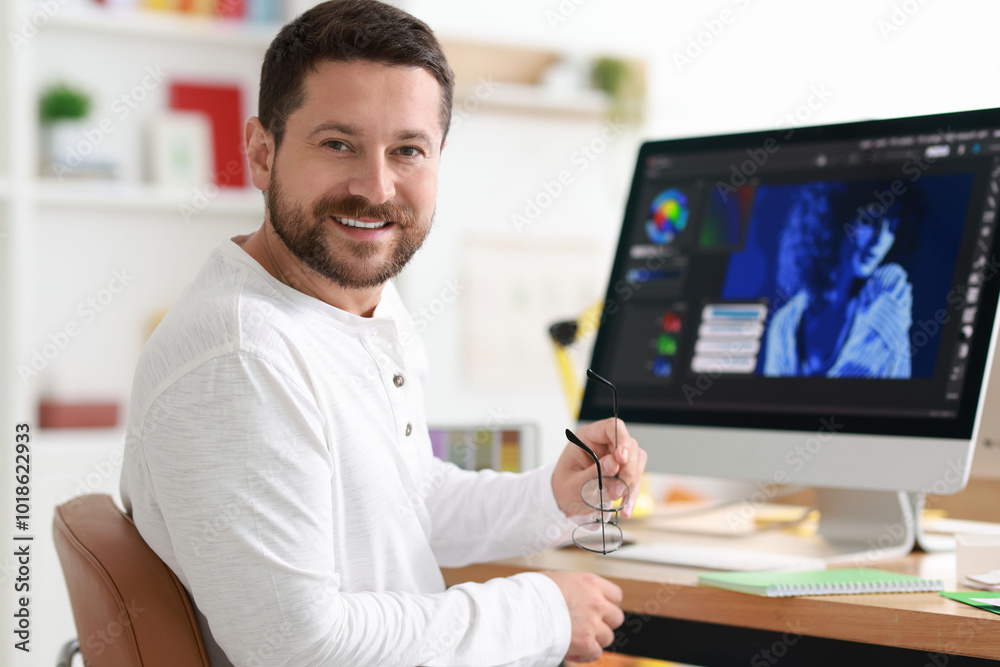 Designer working with computer at table in office Designer working with computer at table in office