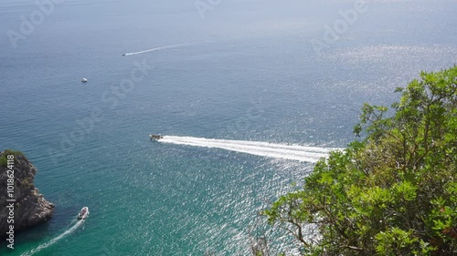 Speedboat creating waves in the ocean water.
