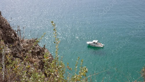 The view is taken from an elevated perspective, showcasing the expansive, calm ocean surface. 