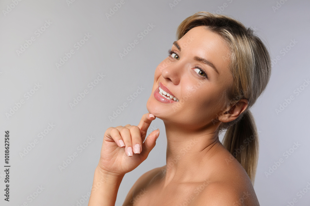 Cosmetology. Beautiful woman with perfect skin on grey background Cosmetology. Beautiful woman with perfect skin on grey background