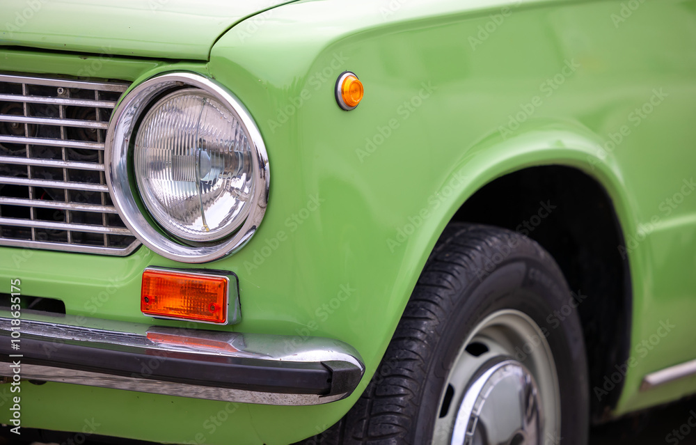 Detail of classic style searchlight of green Lada car, Pécs, Hungary - 23. october 2022. Detail of classic style searchlight of green Lada car, Pécs, Hungary - 23. october 2022.