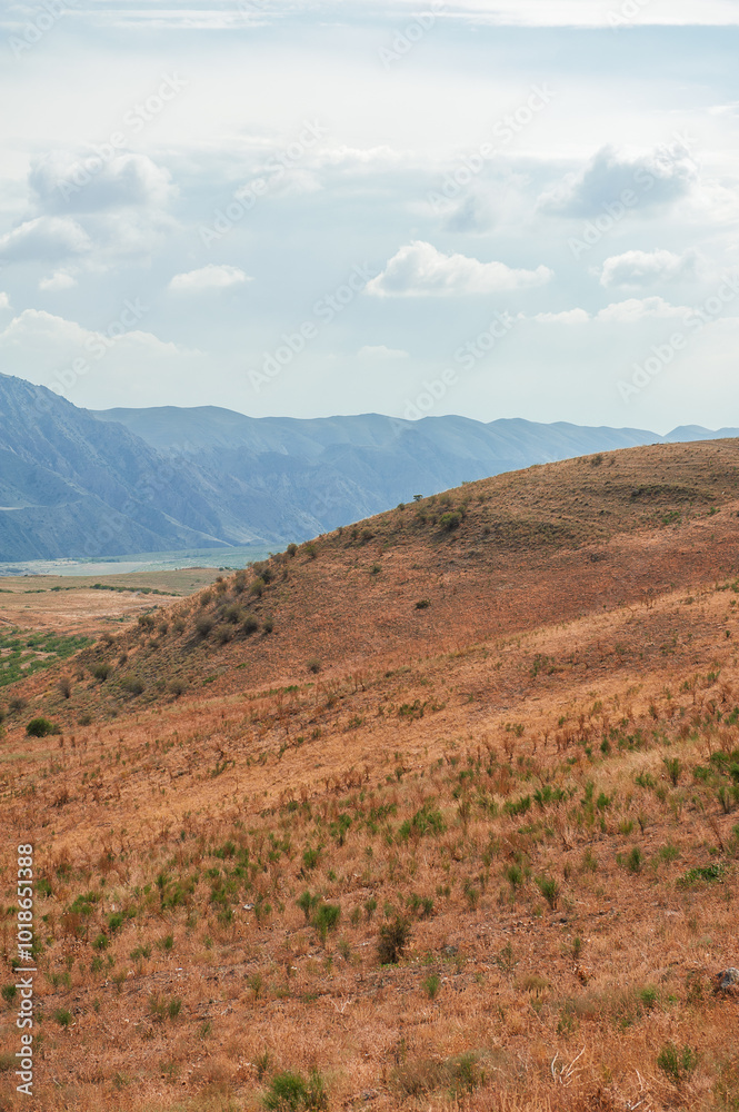 Majestic mountains under a blue sky filled with clouds, showcasing natural beauty and rugged terrain Majestic mountains under a blue sky filled with clouds, showcasing natural beauty and rugged terrain