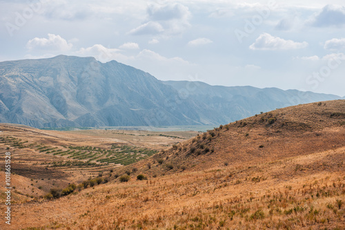 Majestic mountains under a blue sky filled with clouds, showcasing natural beauty and rugged terrain