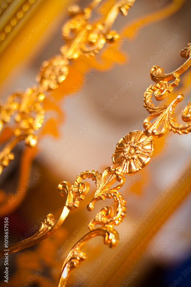 Fototapeta premium Exquisite gold ornate detailing on luxurious antique furniture