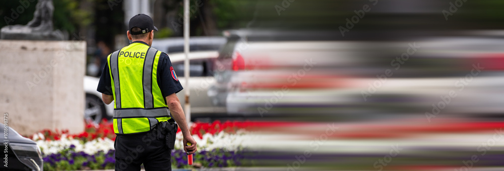 Obraz premium A police officer maintaining order on the street in the city