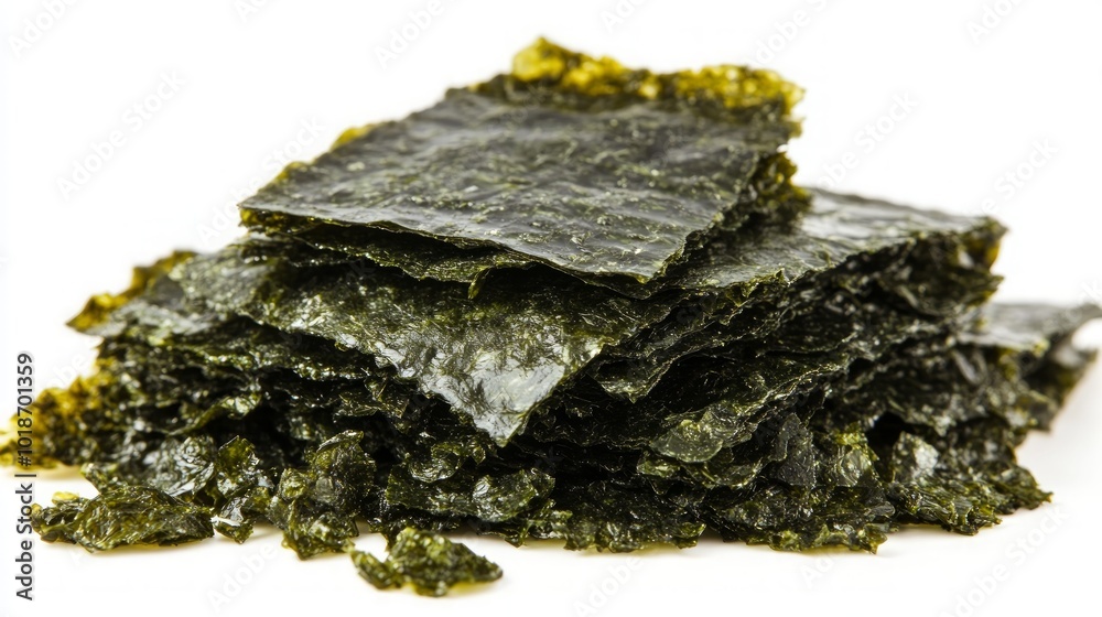 A stack of dried seaweed sheets, also known as nori, isolated on a white background. A stack of dried seaweed sheets, also known as nori, isolated on a white background.