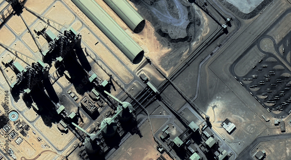 The landscape of a sandy desert and an oil plant in Qatar from a bird's eye view