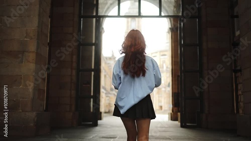 Beautiful girl student enters a bright future, university doors, admission and education, courses, lessons, recess, student life, knowledge, girl with notebooks in hands, confident, intelligence