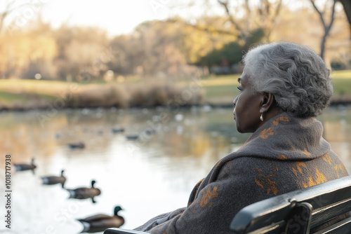 Serene Elderly Woman, Contemplating Ducks by a Peaceful Lake, Reflects on Nature's Beauty, Autumn Tranquility, Senior Wellbeing Concept