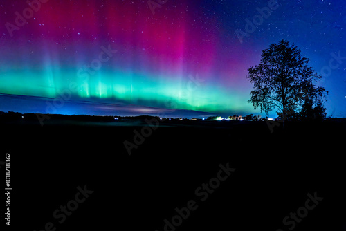 Northern lights dancing over country landscape in noreth of Sweden.