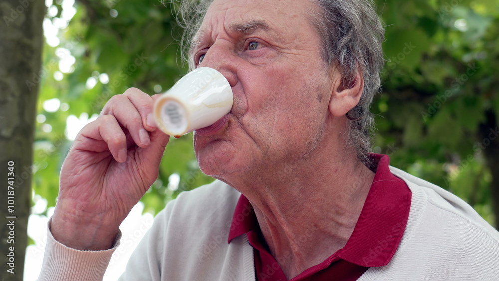 Elderly man outdoors savoring an espresso from a small white cup, enjoying a quiet and reflective moment surrounded by nature. serene scene of simple pleasures and tranquility Elderly man outdoors savoring an espresso from a small white cup, enjoying a quiet and reflective moment surrounded by nature. serene scene of simple pleasures and tranquility