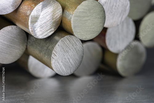 Extreme close-up shot of a stack of steel rods on metal surface, a raw material of the metallurgical industry