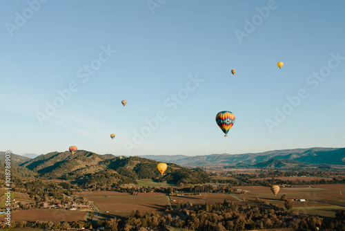 Hot air balloons and fields or hills photo