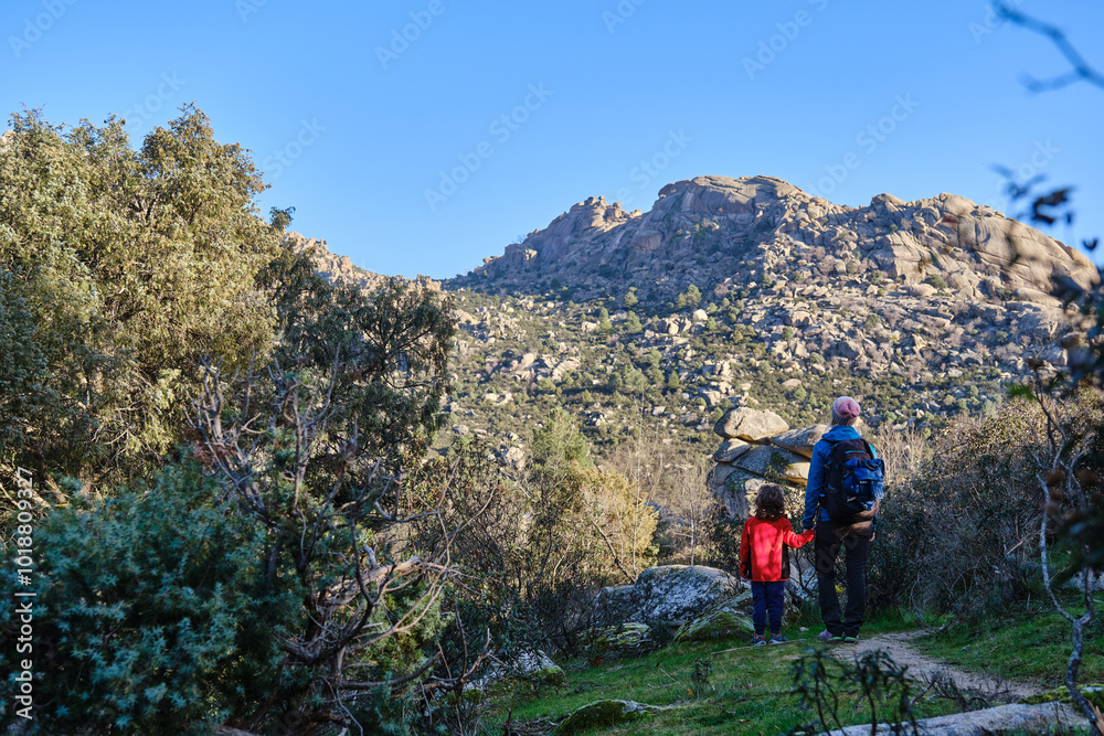 Fototapeta premium A Mother and son treking together admiring mountain scenery.