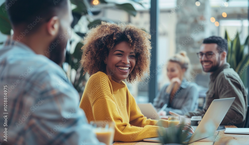 A cheerful student wearing a yellow sweater enjoys collaborating with friends in a lively cafe, surrounded by laptops and coffee cups.
A cheerful student wearing a yellow sweater enjoys collaborating with friends in a lively cafe, surrounded by laptops and coffee cups.