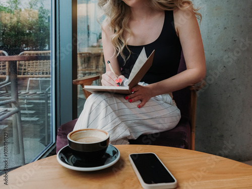 Unrecognisable Woman Journaling  photo