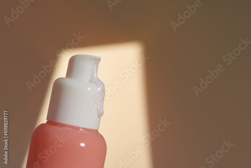 An unlabeled pump bottle of lotion, a streak of dense-textured cream  photo